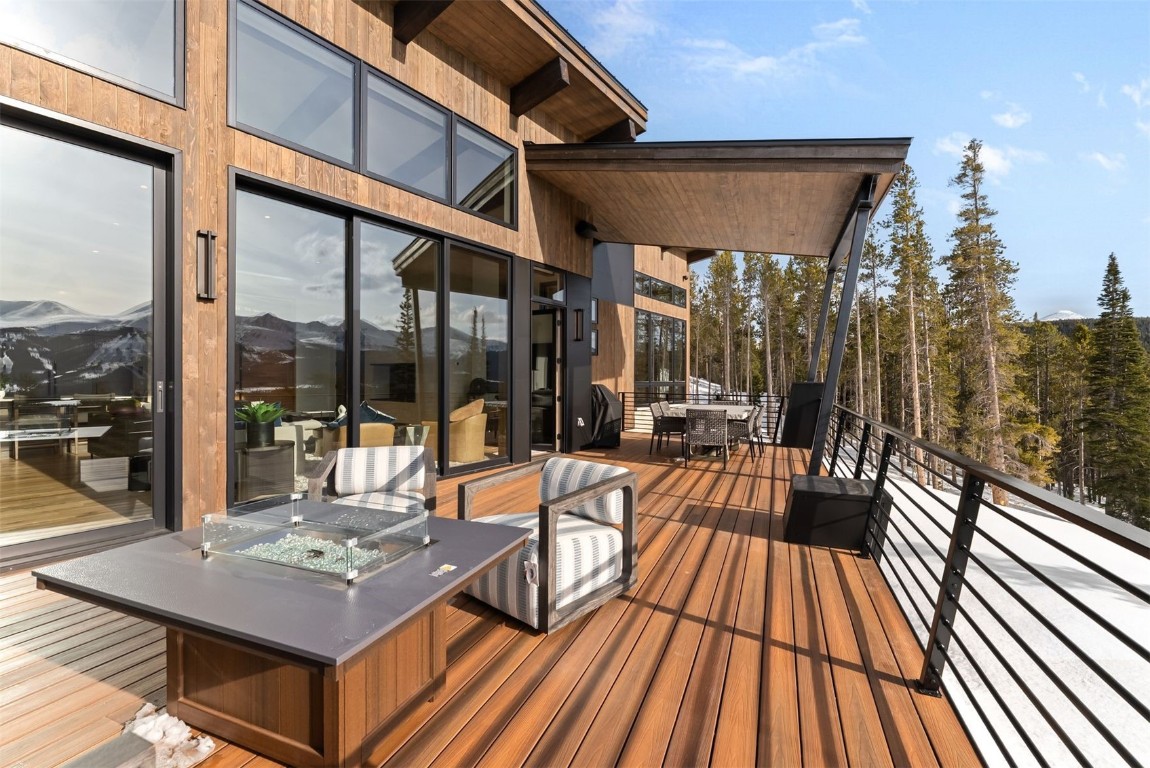 67 Marys Ridge Lane Breckenridge, CO 80424 - Photo 32 of 35 a view of a patio with dining table and chairs with wooden floor and fence