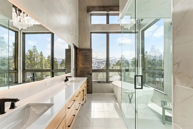 a spacious bathroom with a large tub and floor to ceiling windows