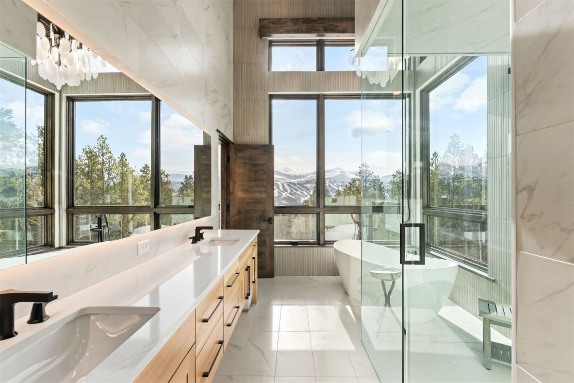 67 Marys Ridge Lane Breckenridge, CO 80424 - Photo 6 of 35 a spacious bathroom with a large tub and floor to ceiling windows