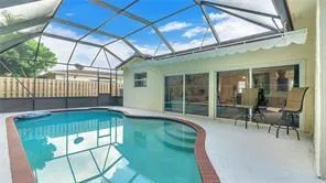 a view of a house with backyard porch and sitting area