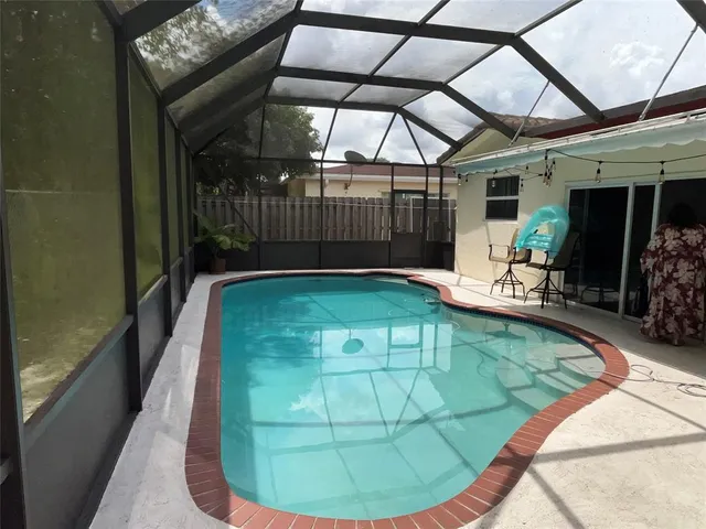 a view of a swimming pool with a patio