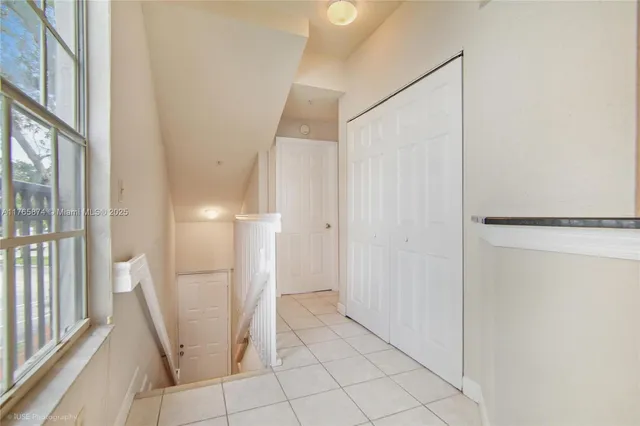 a view of a walk in closet with wooden floor