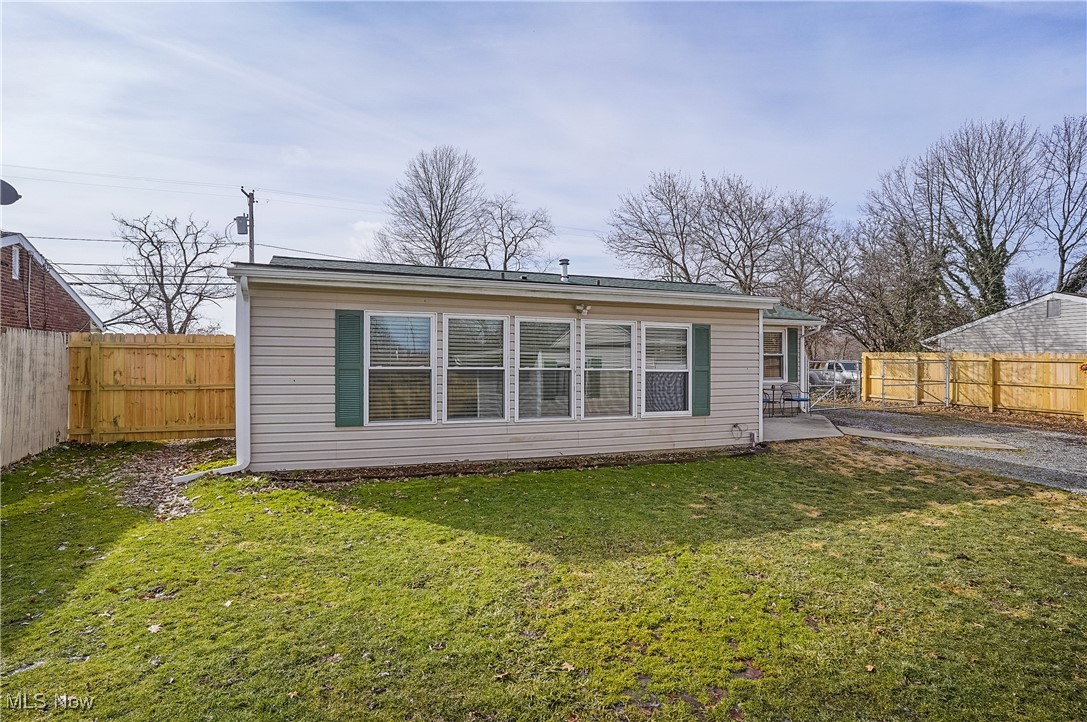 1533 Old Forge Road Kent, OH 44240 - Photo 32 of 33 Back of property with a fenced backyard, a lawn, and a patio