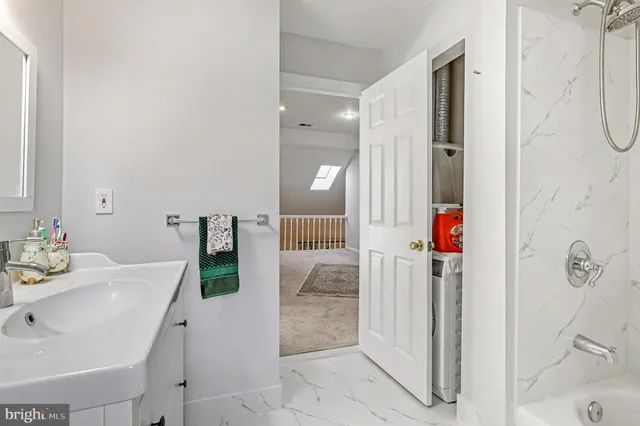 a bathroom with a tub sink and shower