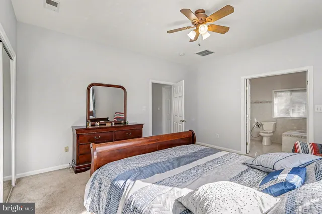 a bedroom with a bed and dresser