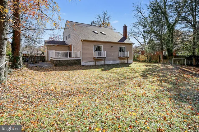 a front view of a house with a yard covered in snow