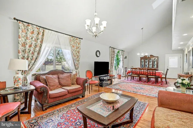 a living room with fireplace furniture and a large window