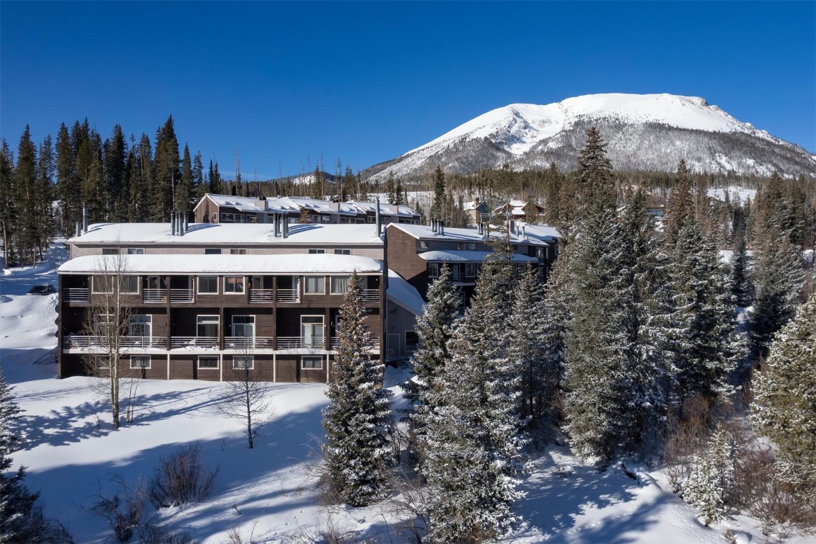 10000 Ryan Gulch Road, Unit G105 Silverthorne, CO 80498 - Photo 24 of 37 Snowy aerial view with a mountain view