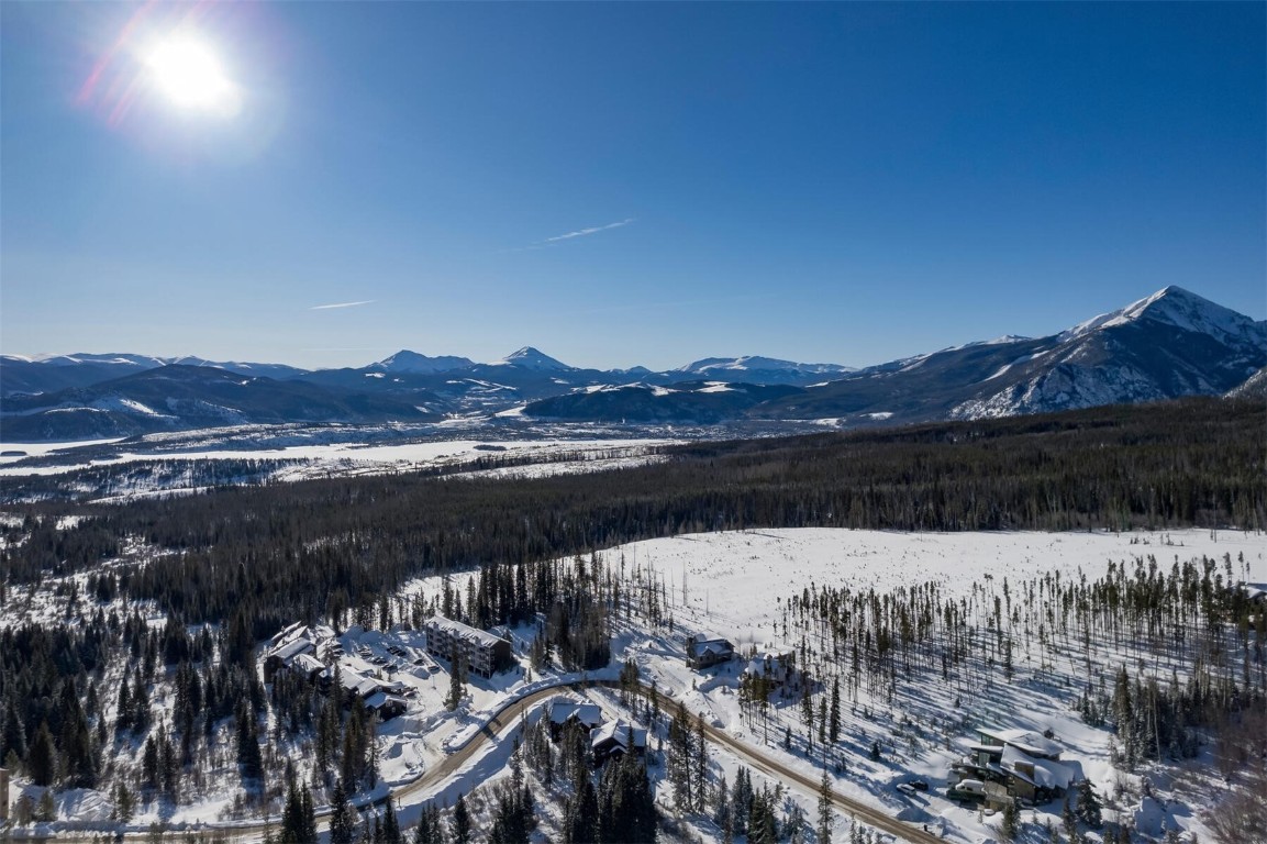 10000 Ryan Gulch Road, Unit G105 Silverthorne, CO 80498 - Photo 27 of 37 Snowy aerial view featuring a mountain view and a forest view