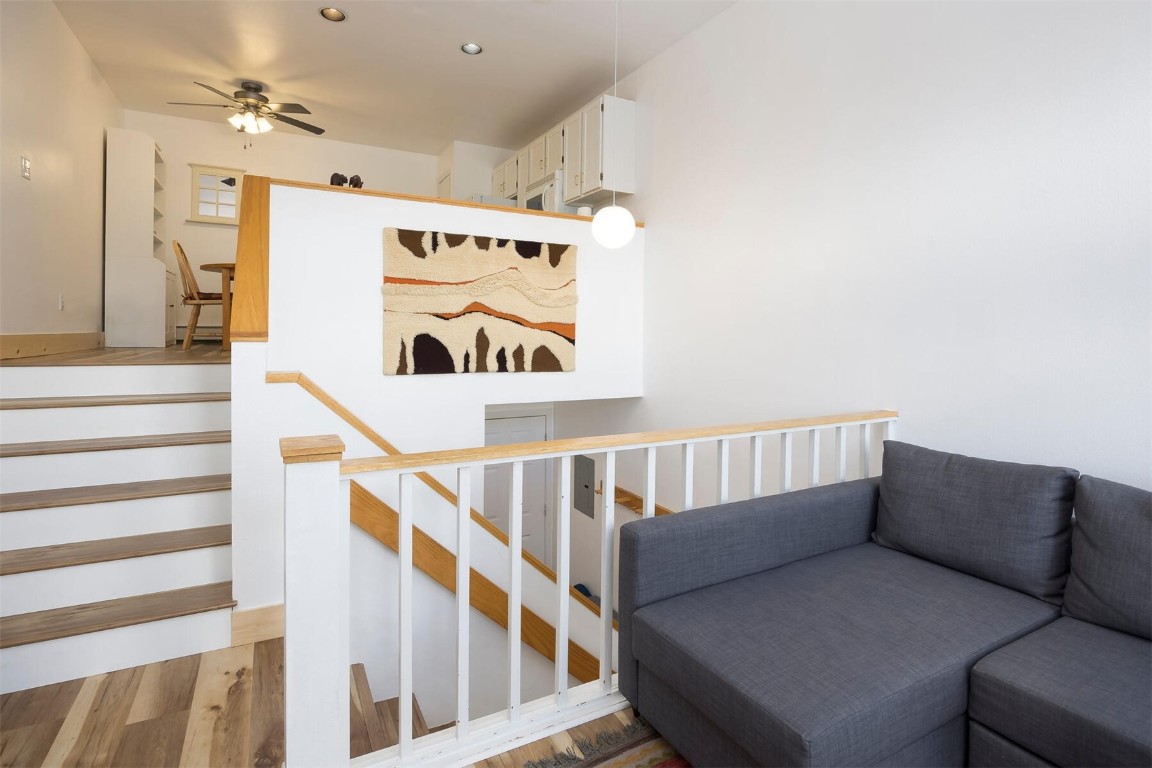 10000 Ryan Gulch Road, Unit G105 Silverthorne, CO 80498 - Photo 5 of 37 Stairs featuring wood finished floors and ceiling fan