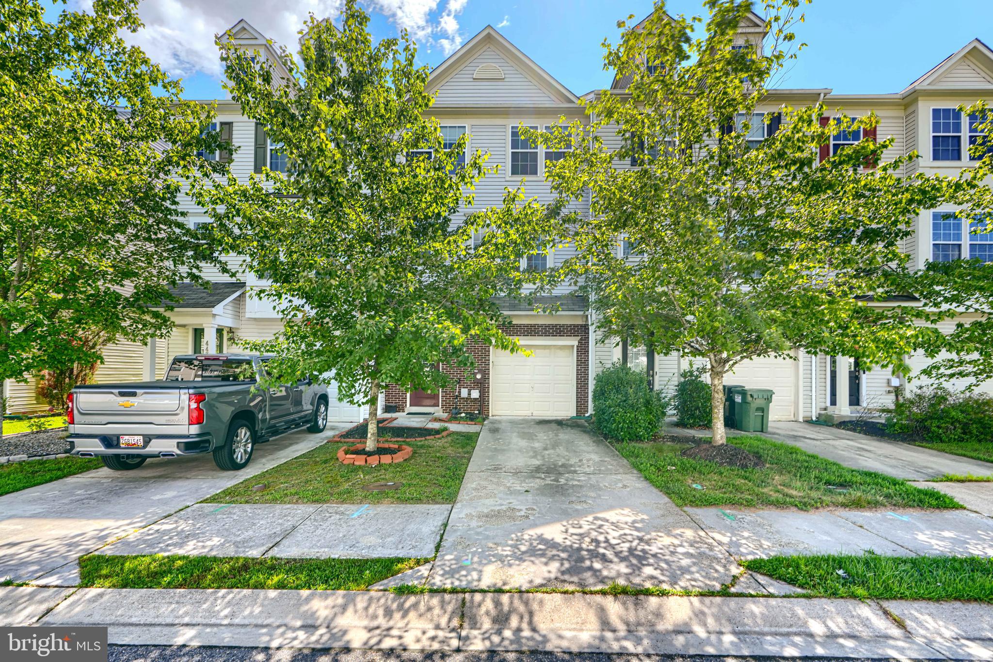 44317 Ocelot Way California, MD 20619 - Photo 1 of 45 a front view of a house with a yard and tree s