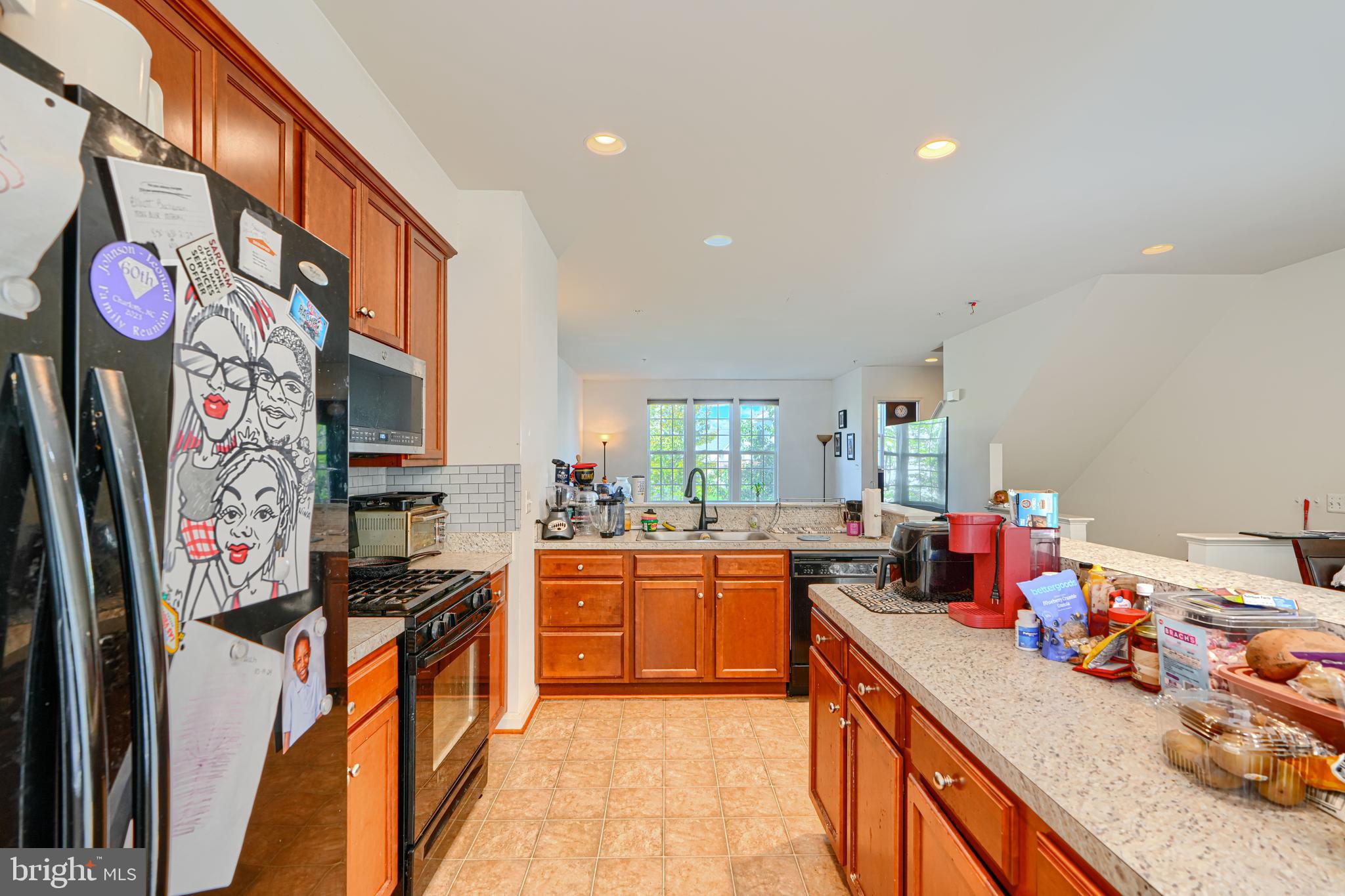 44317 Ocelot Way California, MD 20619 - Photo 22 of 45 a kitchen with stainless steel appliances granite countertop a sink stove and refrigerator