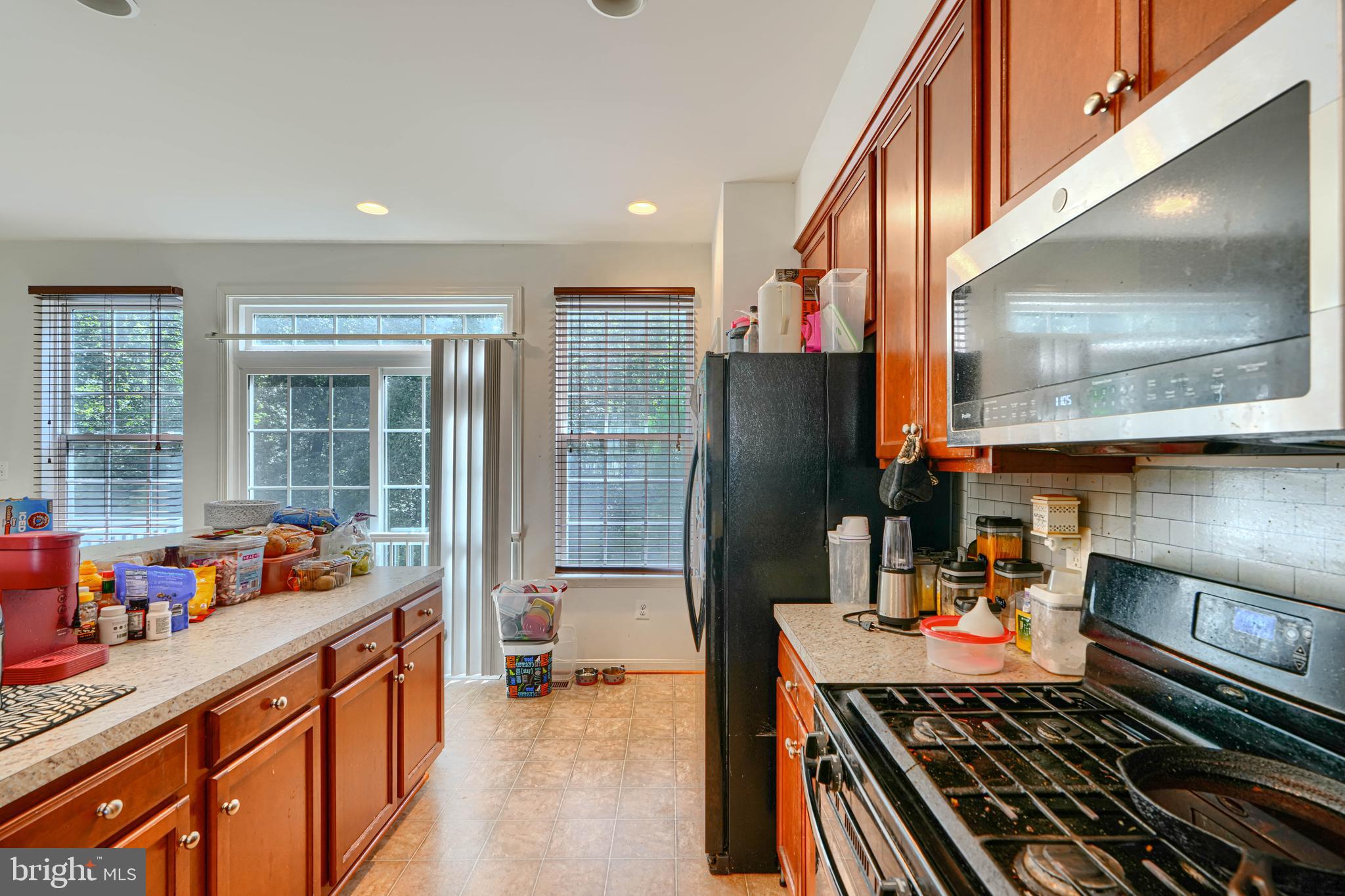 44317 Ocelot Way California, MD 20619 - Photo 24 of 45 a kitchen with stainless steel appliances granite countertop a refrigerator and a stove top oven