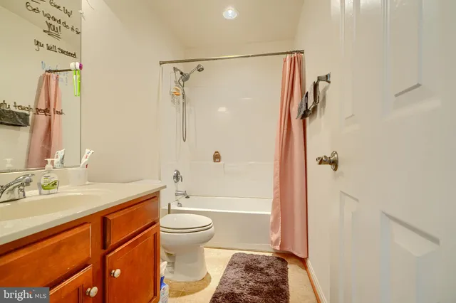 a room with a sink a toilet and a mirror