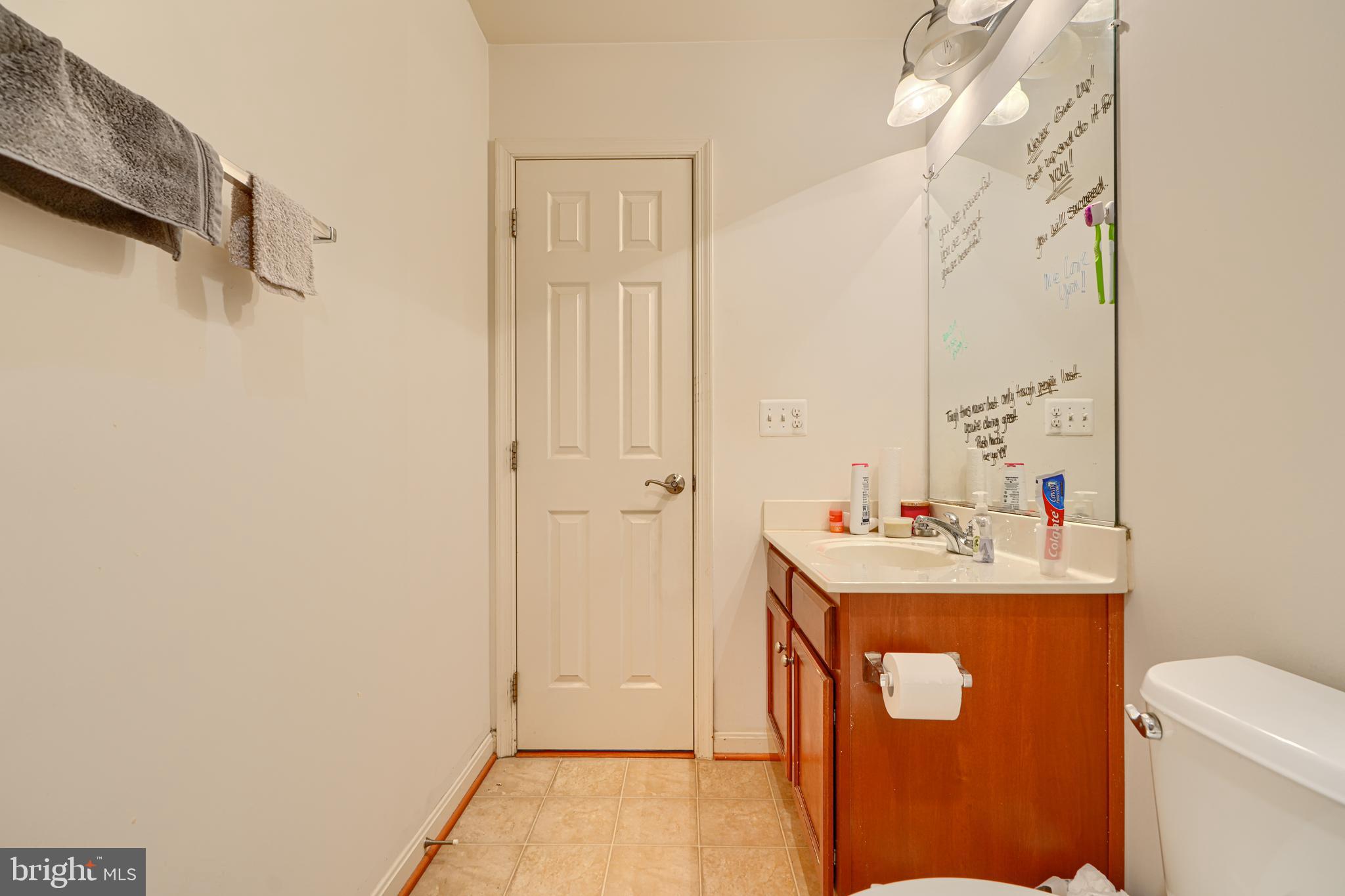 44317 Ocelot Way California, MD 20619 - Photo 36 of 45 a room with a sink a toilet and a mirror