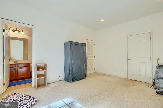 a view of an empty room and kitchen