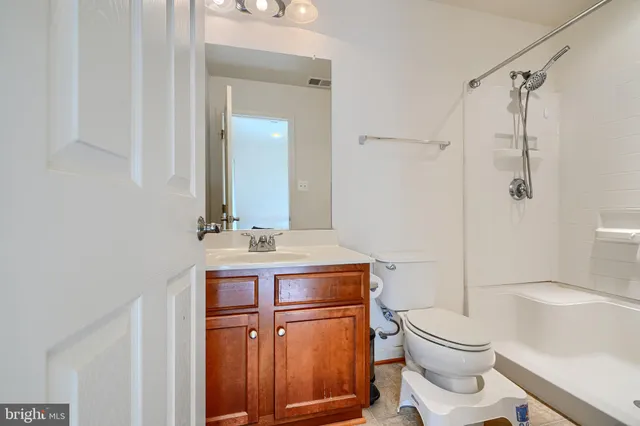 a bathroom with a toilet a sink and a mirror