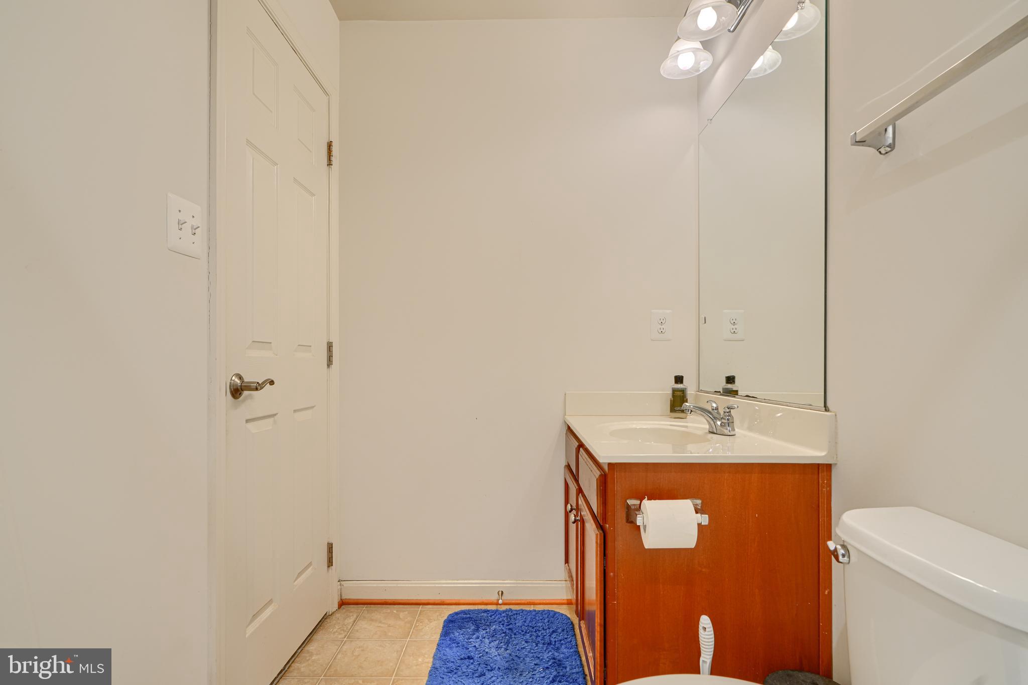 44317 Ocelot Way California, MD 20619 - Photo 9 of 45 a bathroom with a sink toilet and vanity