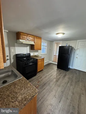 a kitchen with stainless steel appliances granite countertop a stove and a refrigerator