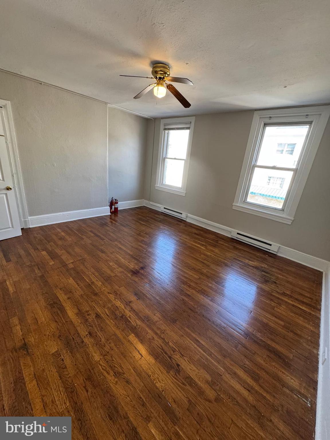 326 East Airy Street, Unit 2 Norristown, PA 19401 - Photo 6 of 8 an empty room with wooden floor and windows