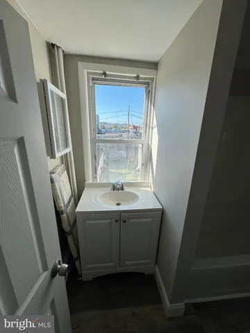 a bathroom with a sink a mirror and a bathtub