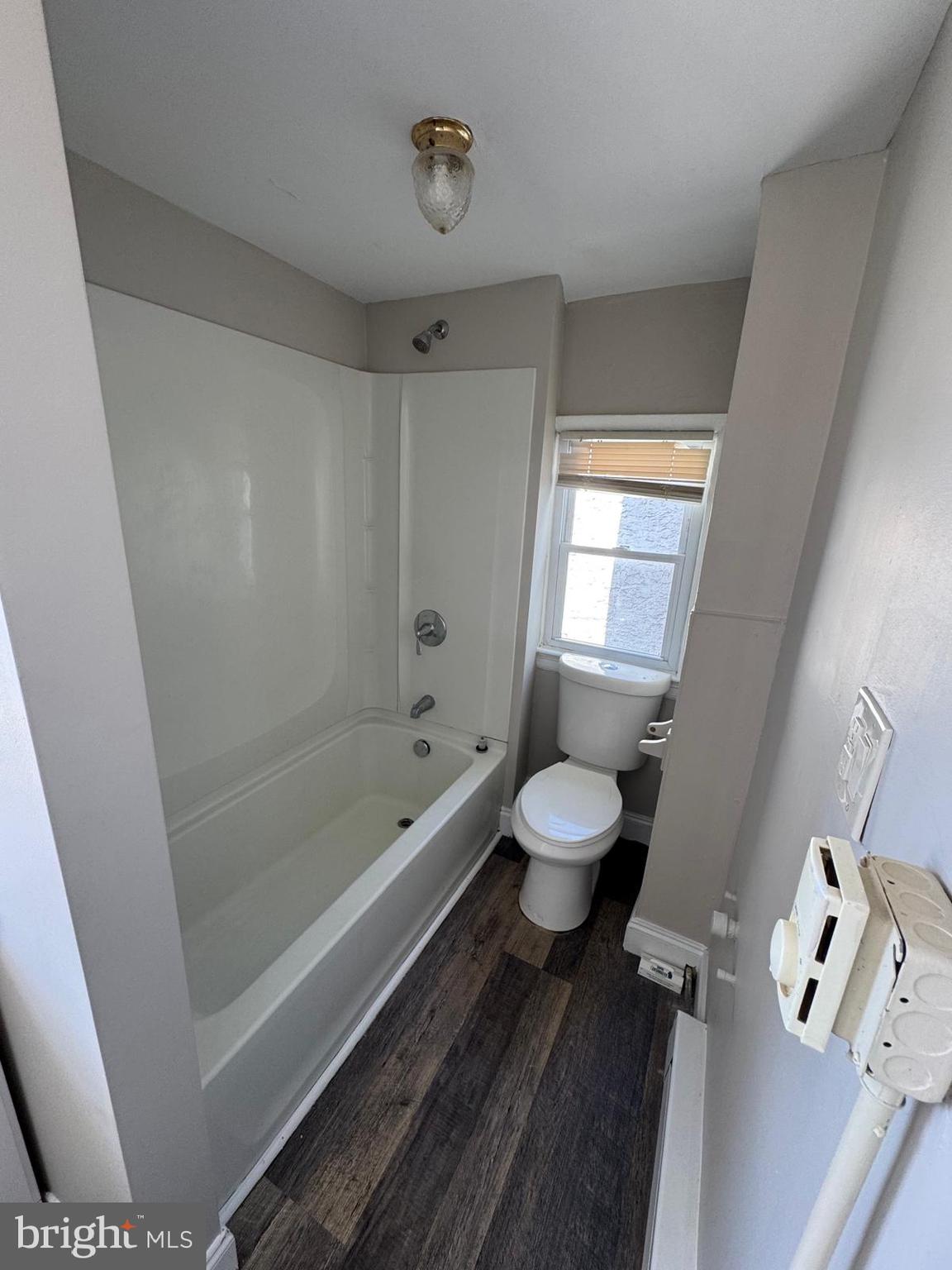 326 East Airy Street, Unit 2 Norristown, PA 19401 - Photo 8 of 8 a bathroom with a toilet a sink a mirror a bathtub and vanity