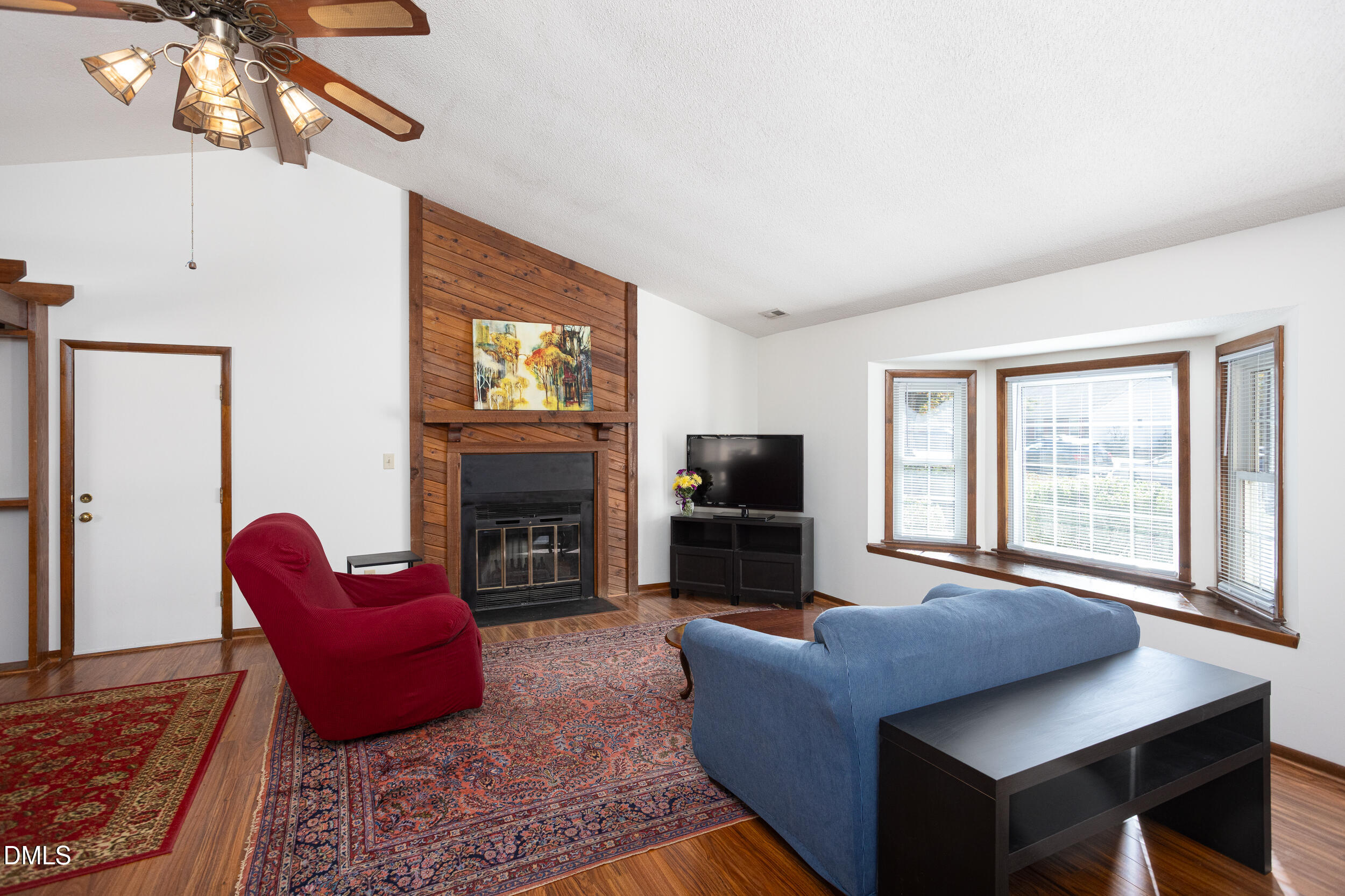 5520 Round Hill Lane Raleigh, NC 27616 - Photo 12 of 29 a living room with furniture a fireplace and a flat screen tv