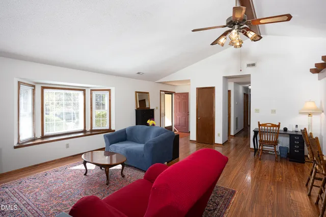 a living room with furniture a dining table and a window