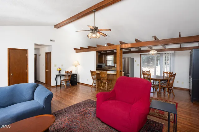 a living room with furniture a ceiling fan and a window