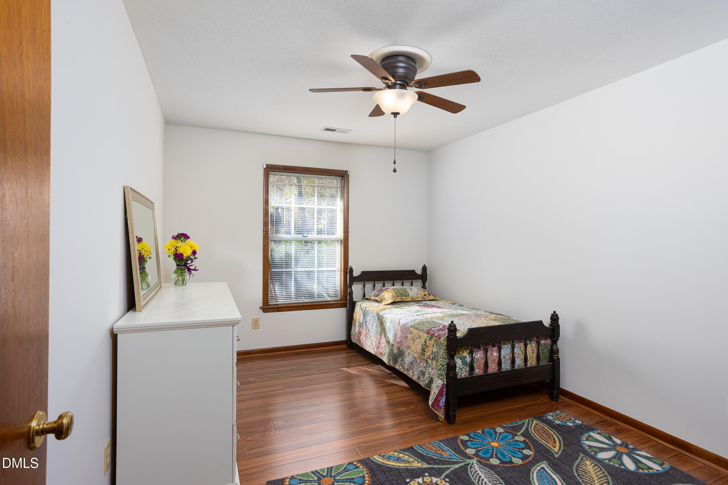 5520 Round Hill Lane Raleigh, NC 27616 - Photo 19 of 29 a bedroom with a bed and a chandelier