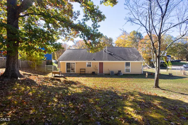 a view of a house with a large tree in front of it