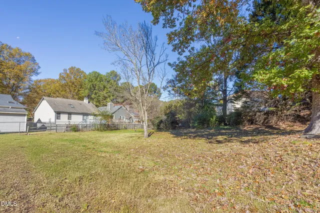 a view of a yard with a house and large tree