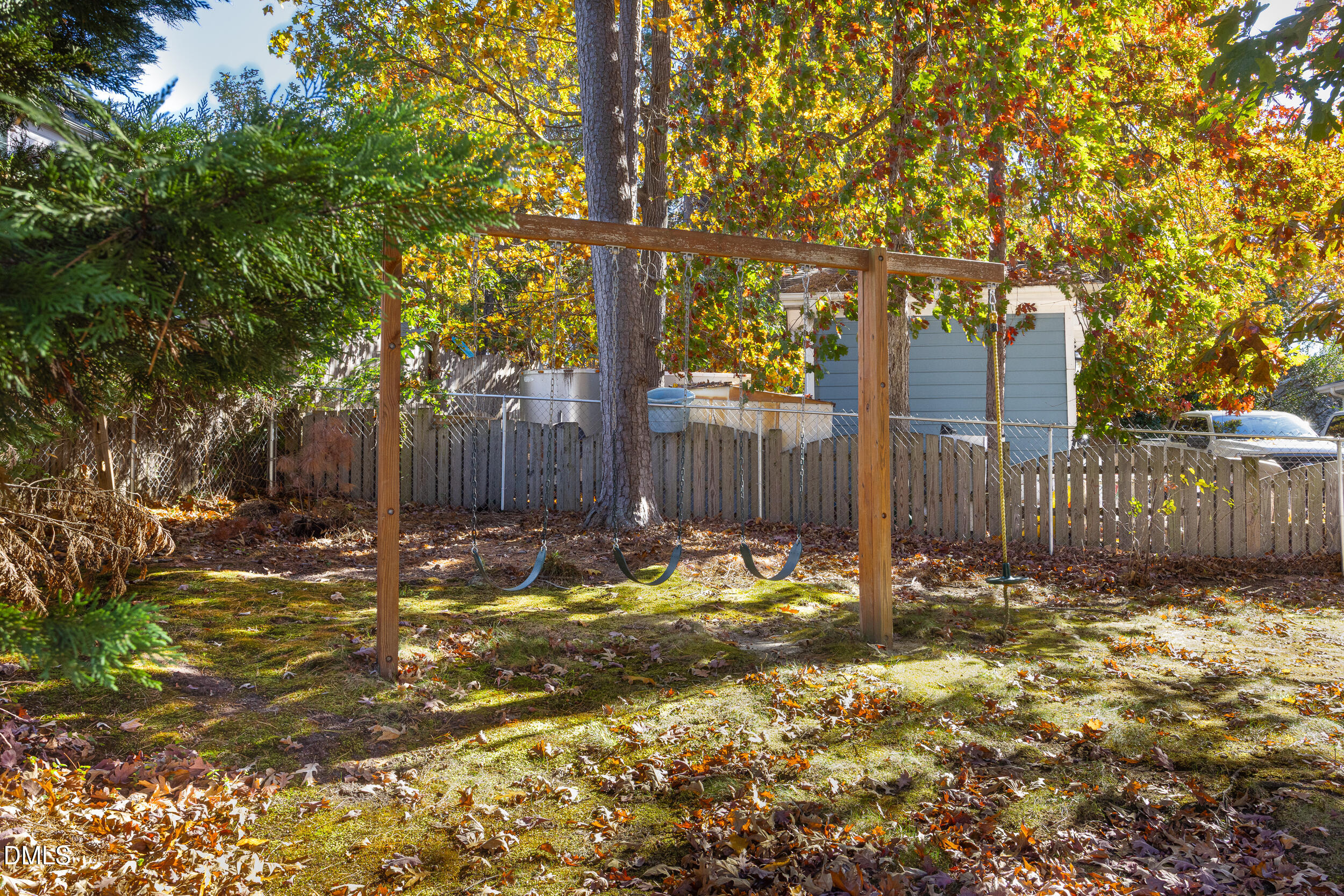 5520 Round Hill Lane Raleigh, NC 27616 - Photo 28 of 29 a backyard of a house with table and chairs and wooden fence