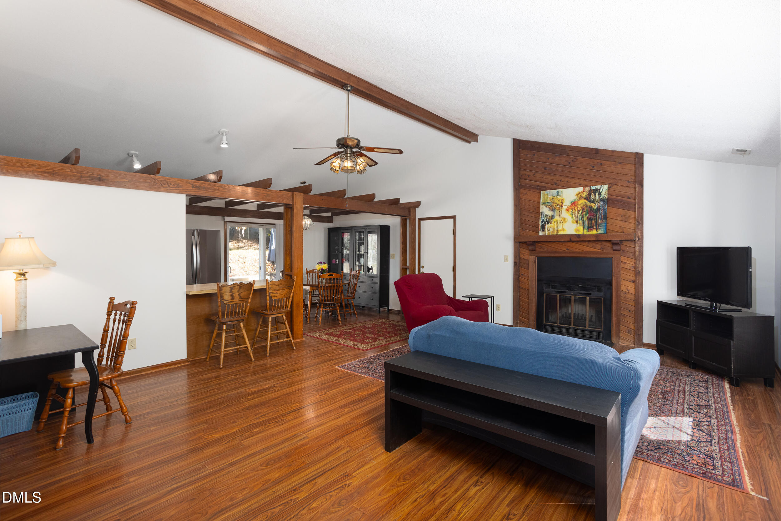5520 Round Hill Lane Raleigh, NC 27616 - Photo 3 of 29 a living room with furniture a fireplace and a flat screen tv