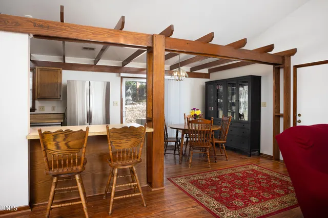 a dining room with furniture a rug and wooden floor