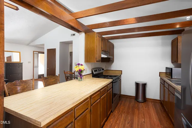 a kitchen with a sink appliances and cabinets