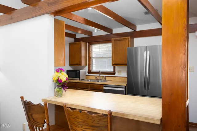 a kitchen with stainless steel appliances granite countertop a refrigerator and a stove