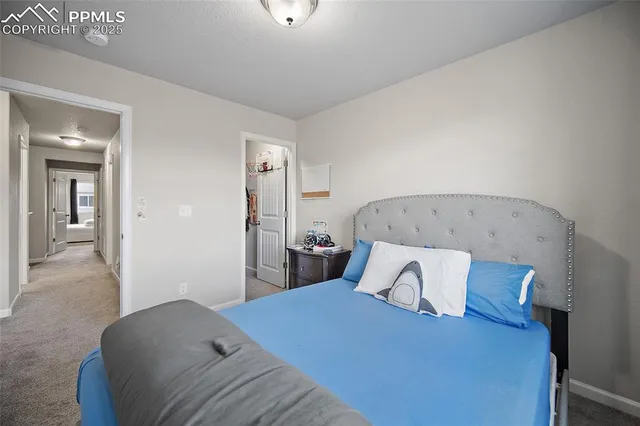 a bedroom with a bed and a night stand