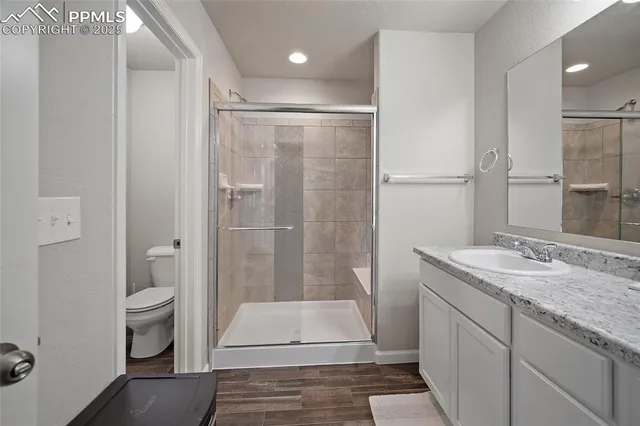 a bathroom with a granite countertop sink toilet and shower