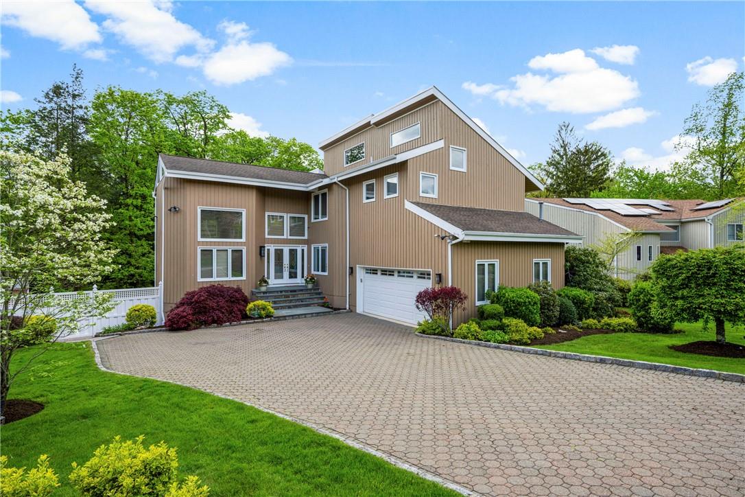 a view of a house with a yard and plants