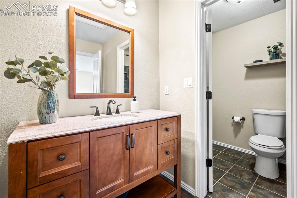 1682 Deer Creek Road Monument, CO 80132 - Photo 19 of 38 Private Primary Ensuite with updated vanity w/granite countertop, tile floors and tub/shower