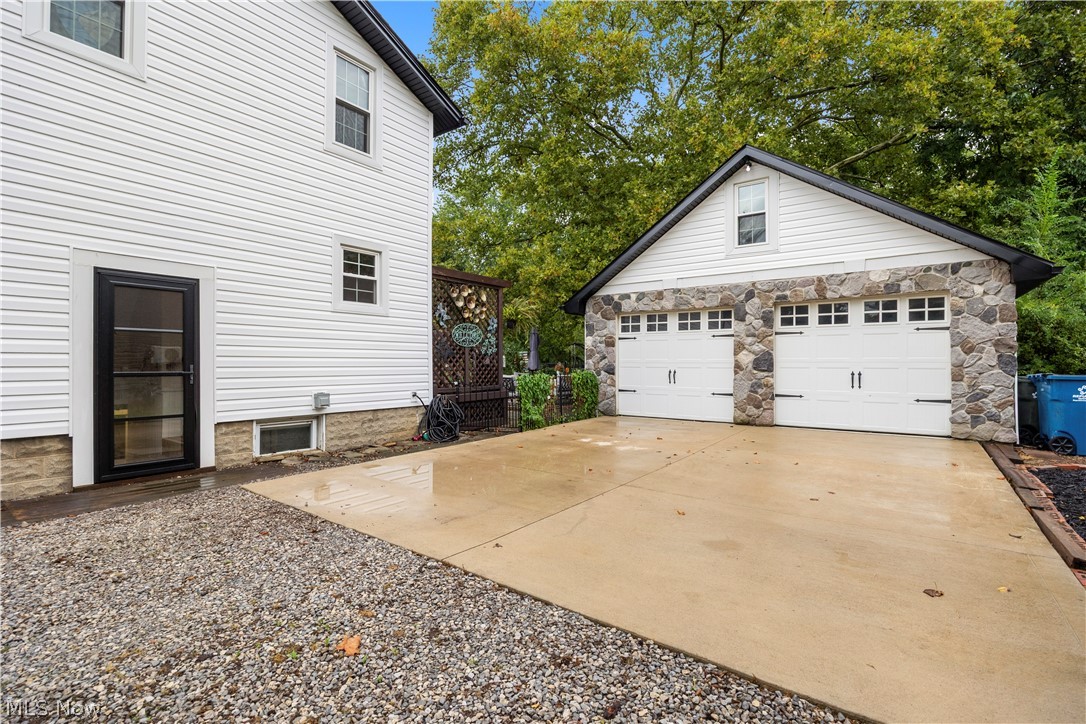 27258 Cook Road Olmsted Falls, OH 44138 - Photo 31 of 44 Two-car garage with stone facade and white paneled doors