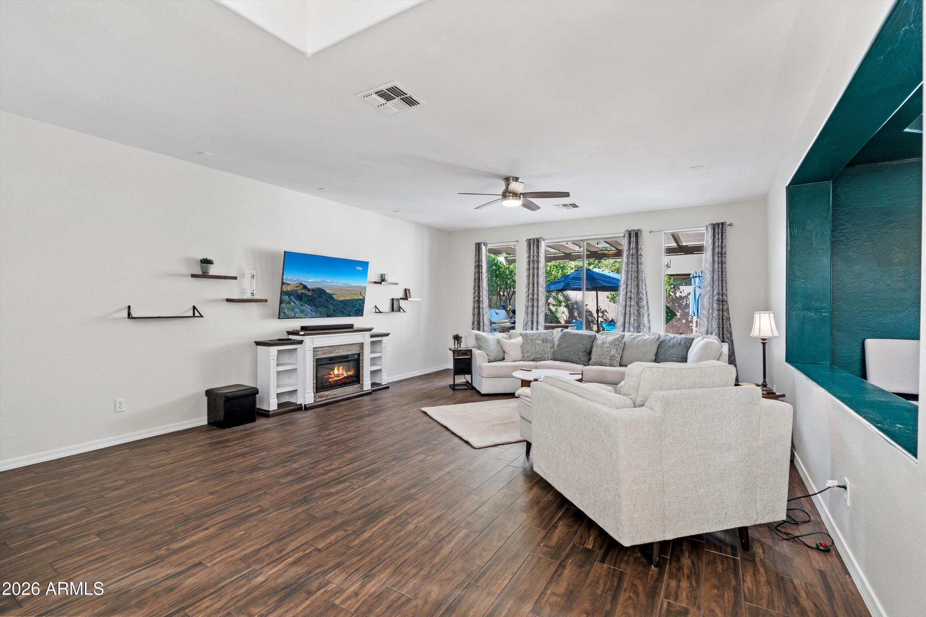 16018 West Shangri La Road Surprise, AZ 85379 - Photo 16 of 40 a living room with furniture and wooden floor