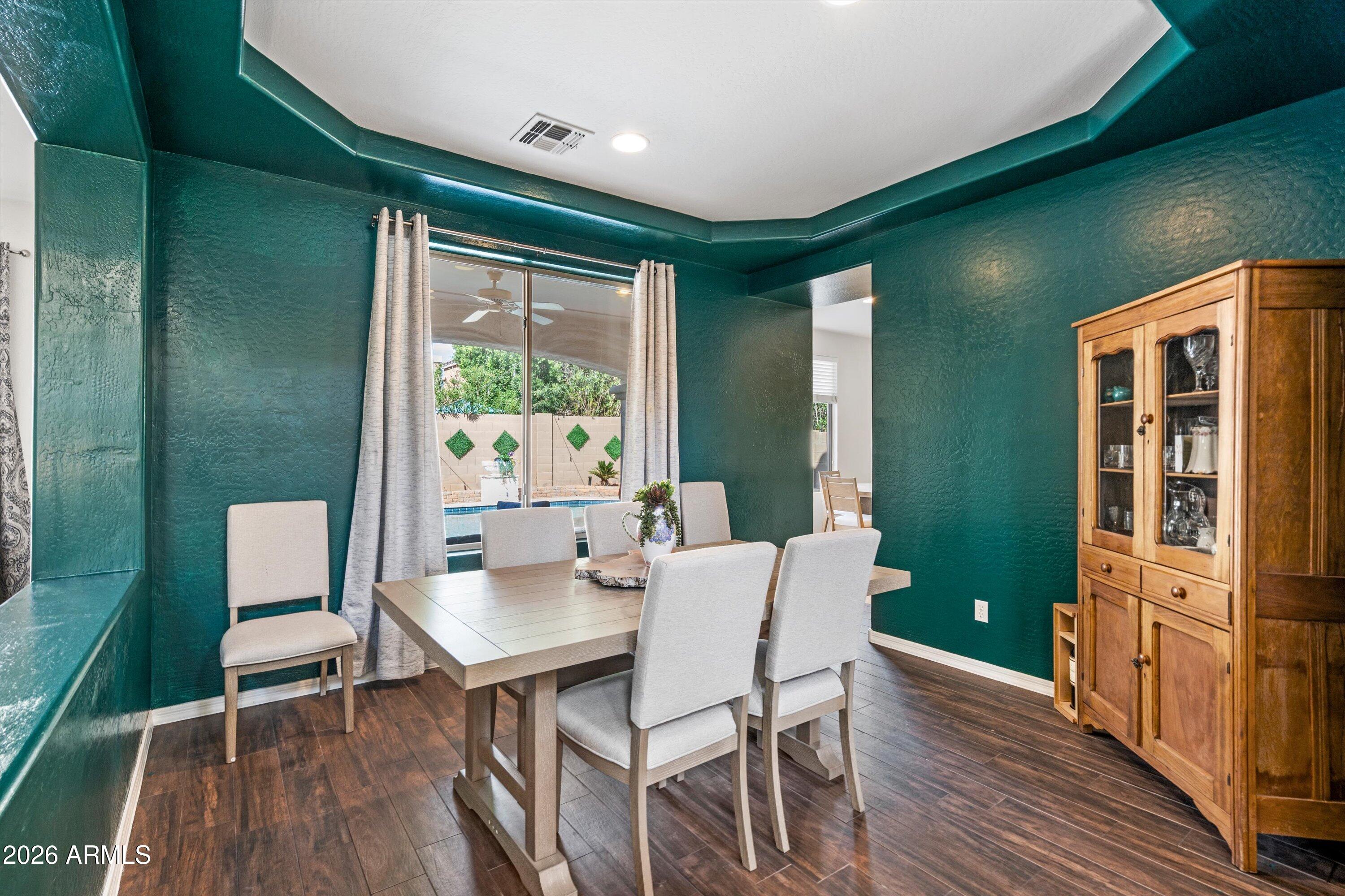 16018 West Shangri La Road Surprise, AZ 85379 - Photo 18 of 40 a view of a dining room with furniture window and wooden floor