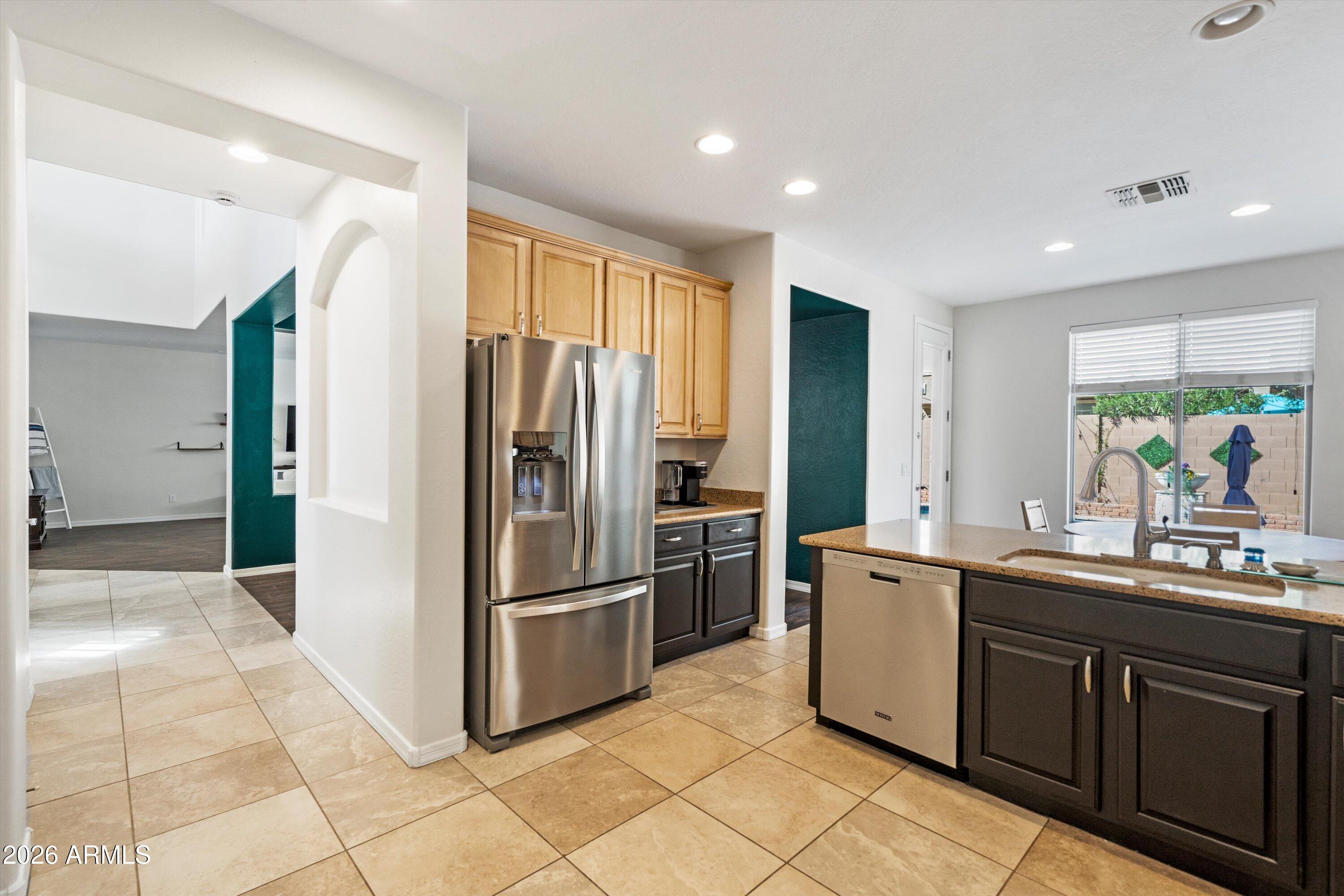16018 West Shangri La Road Surprise, AZ 85379 - Photo 22 of 40 a kitchen with stainless steel appliances a sink and a refrigerator