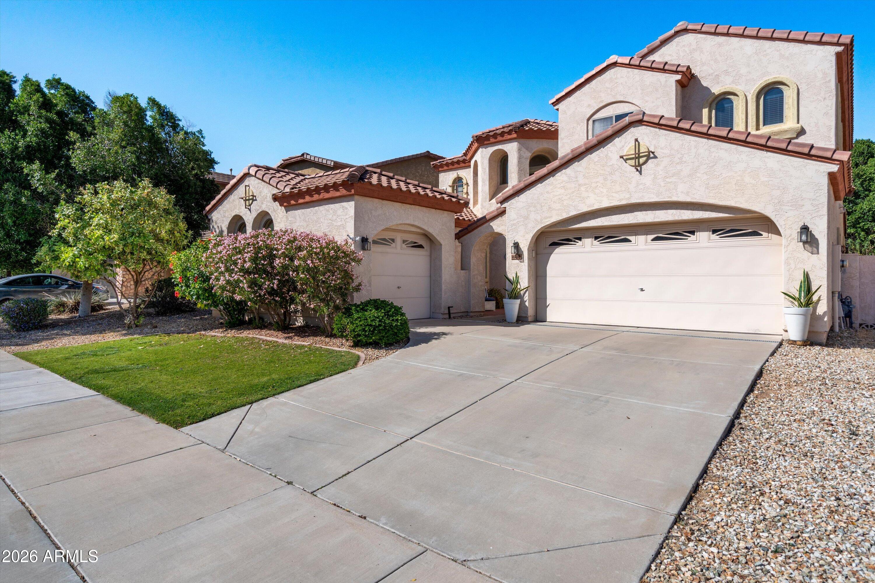16018 West Shangri La Road Surprise, AZ 85379 - Photo 2 of 40 a front view of a house with a yard and garage