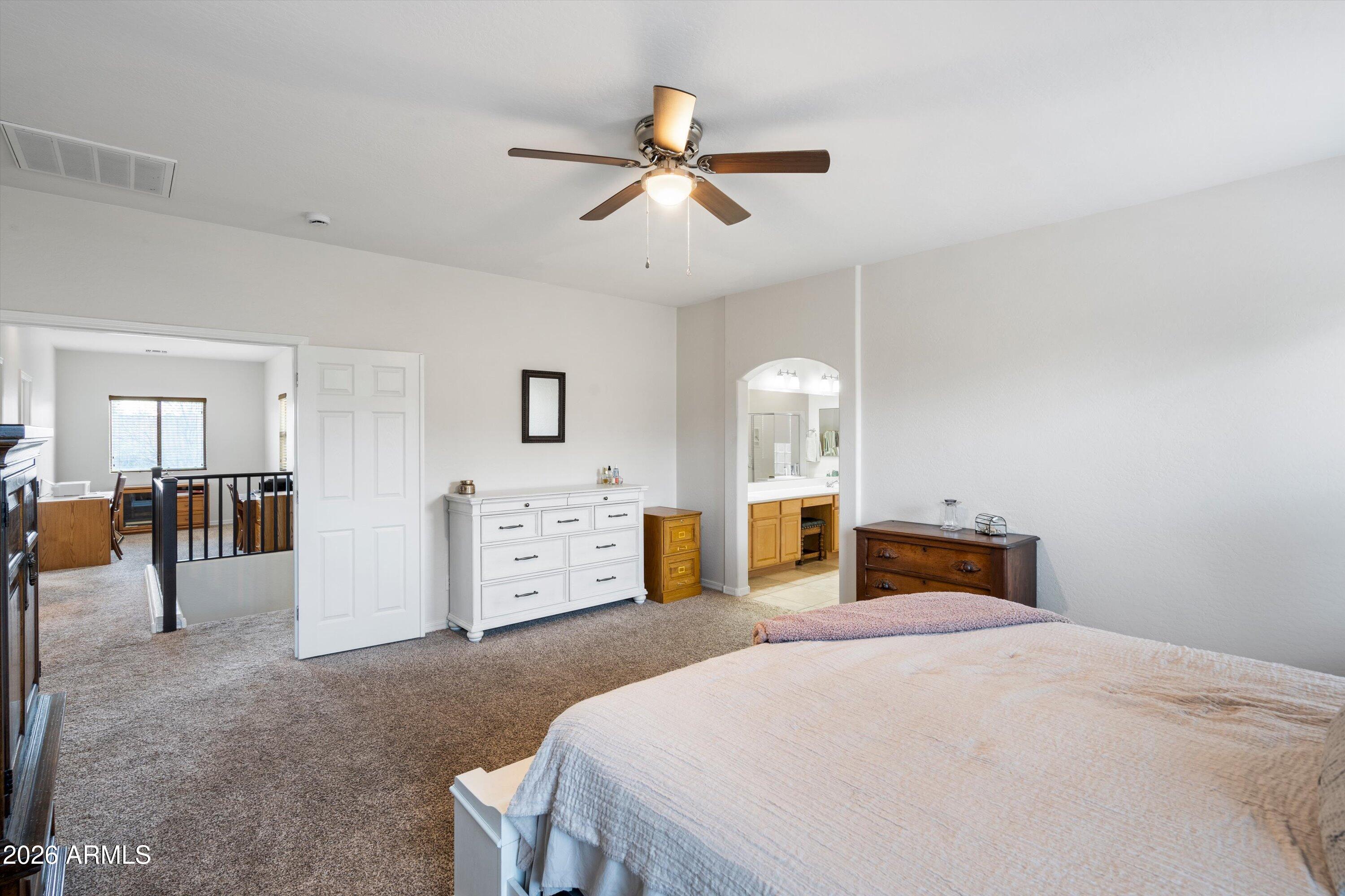 16018 West Shangri La Road Surprise, AZ 85379 - Photo 28 of 40 a bedroom with furniture and window