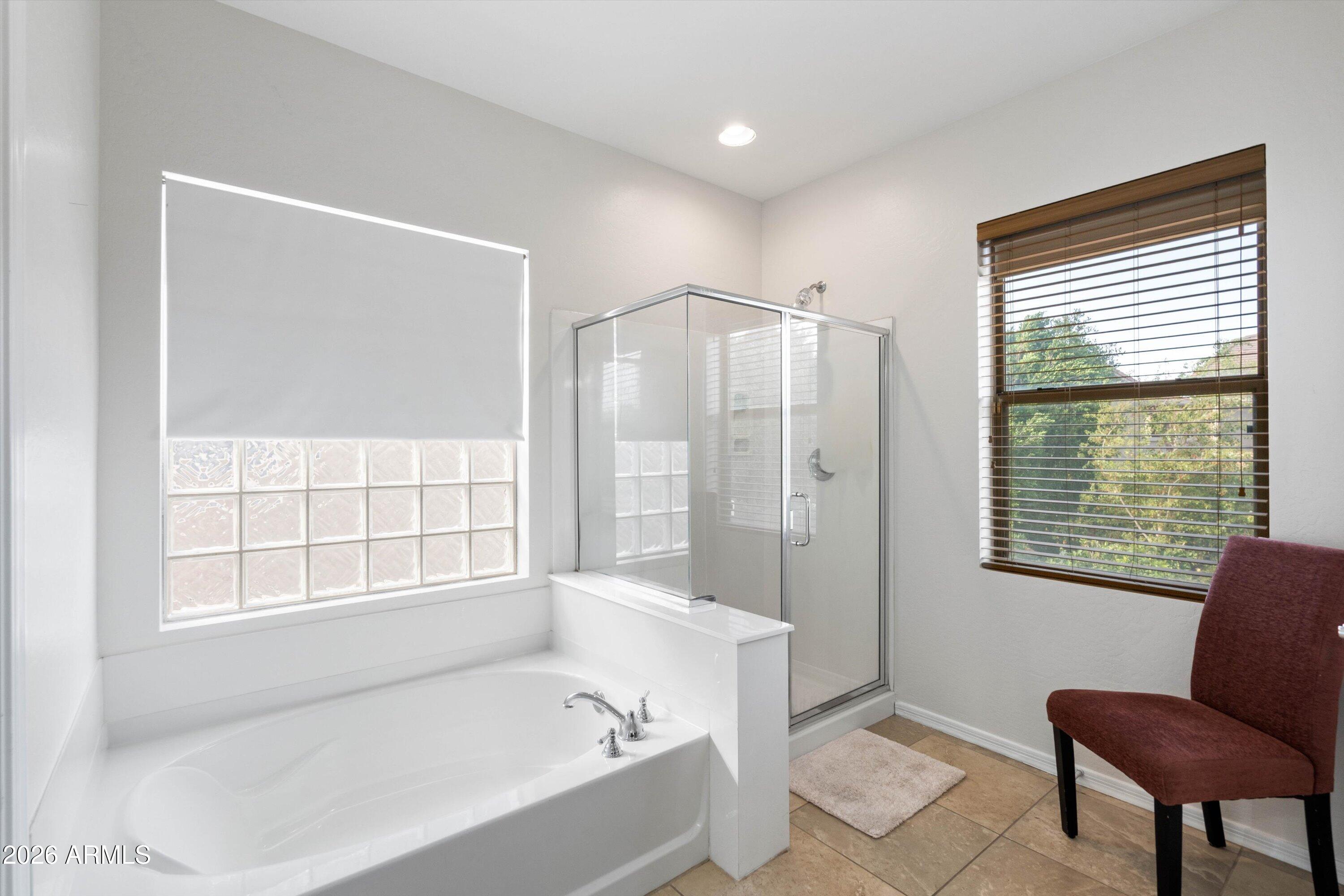 16018 West Shangri La Road Surprise, AZ 85379 - Photo 30 of 40 a bathroom with a bathtub and a shower