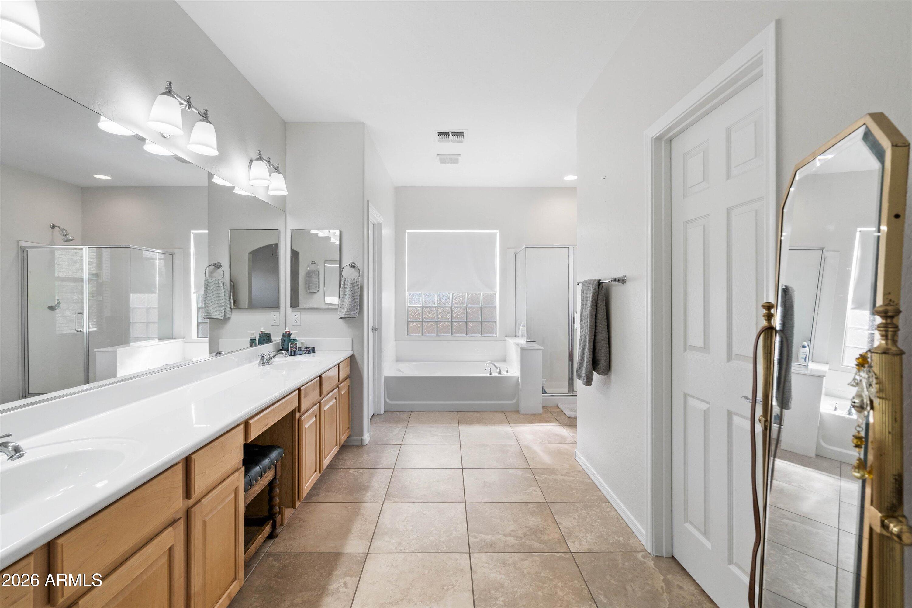 16018 West Shangri La Road Surprise, AZ 85379 - Photo 31 of 40 a large bathroom with a glass shower door