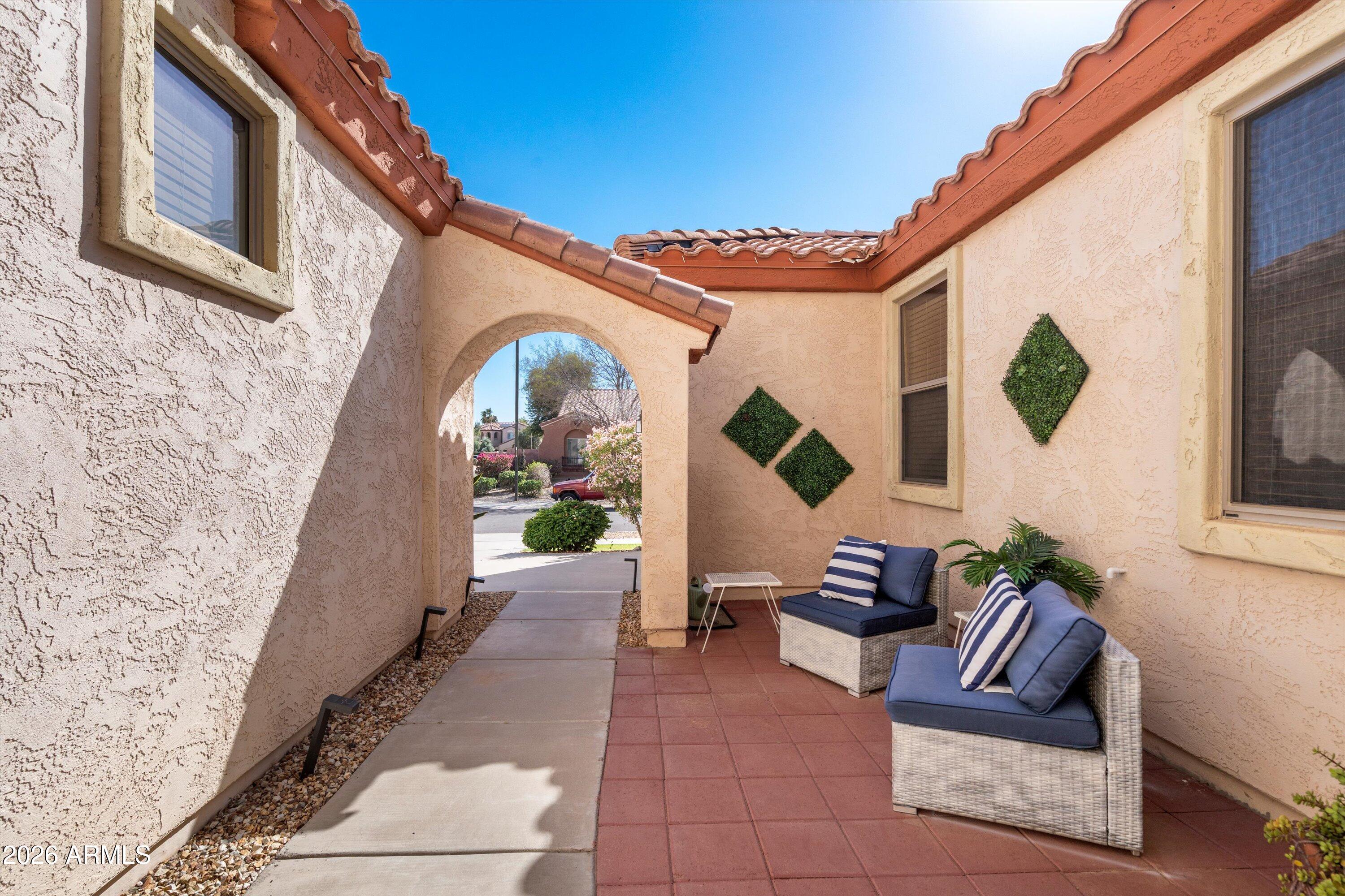 16018 West Shangri La Road Surprise, AZ 85379 - Photo 6 of 40 a view of living room with patio furniture and potted plants
